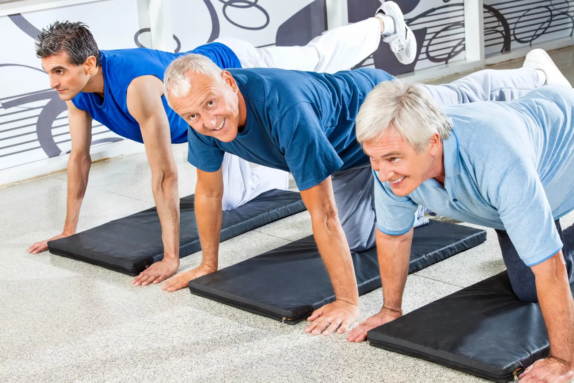 Senior*innen trainieren gemeinsam im Fitnessstudio.